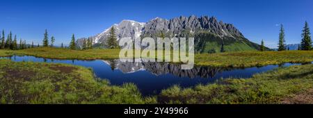 Der Hochkoenig an einem sonnigen Sommertag, blauer Himmel, Reflexion in einem kleinen Teich Mühlbach am Hochkönig Österreich Stockfoto