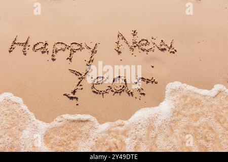 Inschrift Happy New Year am Meer Stockfoto