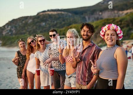 Porträt, Gruppe und Freunde mit Happy at Beach für Sommerurlaub, Freundschaft und gemeinsame Reise in Miami. Lächeln, Leute und Wiedersehen feiern mit Stockfoto