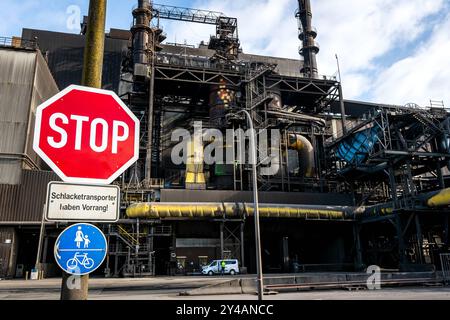 Bremen, Deutschland. September 2024. Ein Stoppschild vor dem Stahlwerk ArcelorMittal Bremen. Die Umstrukturierung des Stahlwerks Bremen wirkt sich auf die Arbeitsweise des Werks und die Belegschaft aus. Bundesarbeitsminister Heil besucht das Stahlwerk, um sich über die Veränderungen zu informieren. Künftig wird die Anlage Wasserstoff zur vergleichsweise klimafreundlichen Stahlerzeugung verwenden. Quelle: Sina Schuldt/dpa/Alamy Live News Stockfoto