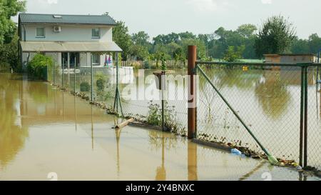 Überflutetes Haus Fluss Hochwasser Sandsackschutz nach Wasserfolgen beschädigt wütende Sperrmauer Regen Bedrohung Häuser bauen Dörfer Autos Stockfoto