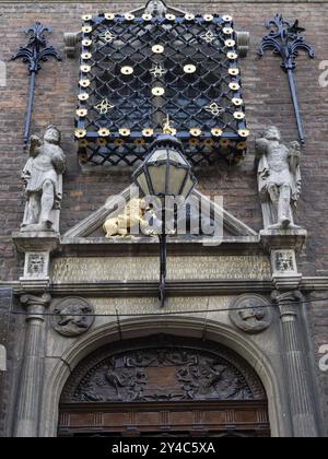 Ein historisches Gebäude mit kunstvollen Skulpturen und Dekorationen über der Haustür, nijmegen, niederlande Stockfoto