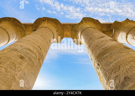 Großartige Säulen im Karnak-Tempel von Luxor und blauer Himmel. Ansicht von unten Stockfoto