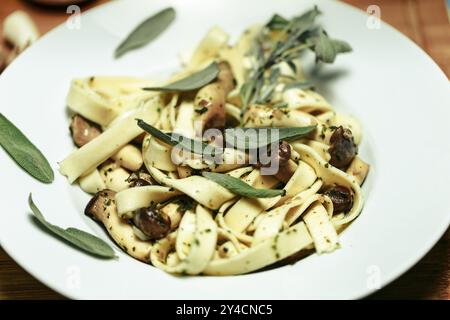 Spaghetti artigianale mit Kräuterpilzen und Salbei Stockfoto