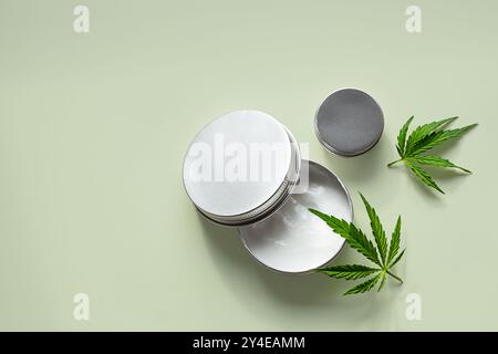 Hanfblätter und Kosmetikgläser mit natürlichen Hautpflegeprodukten. Stockfoto