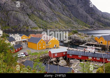 Typische Rourbuer Fischerhütten im Dorf Lofoten Nusfjord an einem regnerischen Tag, im Sommer. Traditionelles norwegisches rotes Holzhaus Stockfoto