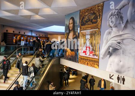 Paris (Frankreich): Touristen in der Halle des Louvre-Museums unter der Struktur der Großen Pyramide. Touristen auf der Treppe und Porträt der Mona Li Stockfoto