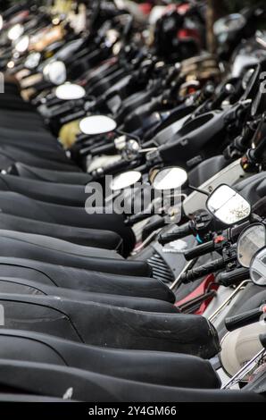 HANOI, Vietnam – Eine lange Reihe von Motorrädern und Motorrollern befindet sich am Straßenrand in der Altstadt von Hanoi. Die Szene spiegelt die Abhängigkeit der Stadt von Zweirädern für den Transport wider, ein häufiger Anblick in diesem geschäftigen Teil Vietnams. Stockfoto