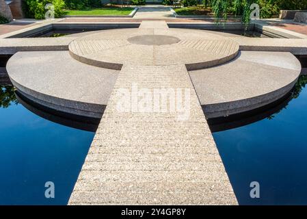 WASHINGTON DC, USA – der Moongate Garden befindet sich zwischen der Freer Gallery of Art und der Arthur M. Sackler Gallery auf dem Gelände von Smithsonian. Dieser asiatisch inspirierte Garten verfügt über Granitskulpturen und einen reflektierenden Pool. Der Garten ist Teil des größeren Enid A. Haupt Gartenkomplexes neben dem Smithsonian Castle. Stockfoto