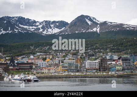 Ushuaia Südlichste Stadt Der Welt Martial Range Berge Beagle-Kanal Argentinien | USHUAIA, Argentinien — Die Stadt Ushuaia, Hauptstadt der Provinz Tierra del Fuego, erstreckt sich entlang des Ufers des Beagle-Kanals, wobei der schneebedeckte Martial Range dramatisch im Hintergrund aufragt. Weit verbreitet als „El Fin del Mundo“ (Das Ende der Welt) vermarktet und lange als die südlichste Stadt der Welt gefördert, wird Ushuas geografischer Anspruch nun von Puerto Williams, Chile, angefochten, dessen Neuklassifizierung als Stadt durch das chilenische Statistikinstitut im Jahr 2019 einen Rivalen auf einem etwas niedrigeren Breitengrad auf der gegenüberliegenden Seite platziert Stockfoto