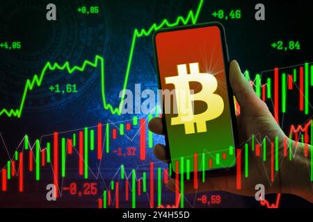 Bayern, Deutschland - 18. September 2024: Bitcoin BTC als Symbol für Kryptowährungen auf einem Smartphone-Display. Konzept von Kryptoschwankungen an Kryptobörsen und am Kapitalmarkt aufgrund der Stärke und des Verlusts von Währungen. Photomontage *** Bitcoin BTC als Symbol für Kryptowährungen auf einem Display eines Smartphones. Konzept zu Kryptoschwankungen an den Kryptobörsen und dem Kapitalmarkt durch Stärke und Verlust der Währungen. Fotomontage Stockfoto