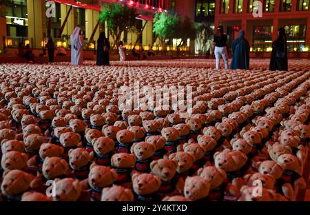 DER SYRISCHE KÜNSTLER BASHIR MUHAMMAD S KUNSTINSTALLATION IN DOHA ECHO OF LOST INNOCENCE Menschen besuchen die Installation von Teddybären mit dem Titel Echo of Lost Innocence in der Freiluftgalerie Barahat Mashaireb, um auf palästinensische Kinder aufmerksam zu machen, die beim israelischen Angriff auf Gaza am 18. September 2024 in Doha, Katar, ihr Leben verloren haben. Die Installation mit 15.000 Teddybären wurde vom syrischen Künstler Basher Mohamad entworfen. DOHA Katar Copyright: XNOUSHADx Stockfoto