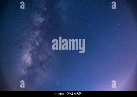 Ein atemberaubender Blick auf die Milchstraße, die sich über dem Nachthimmel über einem ruhigen Meer erstreckt. Die Sternenbande unserer Galaxie ist in all ihrer Pracht sichtbar. Suao Stockfoto