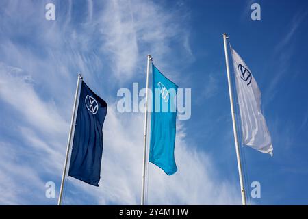 Minsk, Weißrussland, 19. September 2024 - Flaggen mit Logo Volkswagen. Neues Händlerzentrum mit Firmenlogo Stockfoto