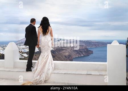 Rückansicht eines Paares an ihrem Hochzeitstag in Santorin in Griechenland. Stockfoto