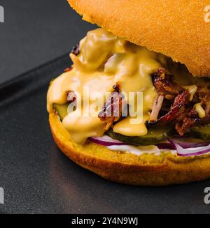 Leckerer Burger mit zerrissenem Fleisch auf schwarzem Tablett Stockfoto