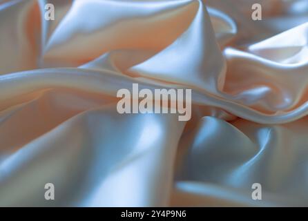 Hintergrund und Textur von Seidengewebe in Pfirsichfarbe Stockfoto