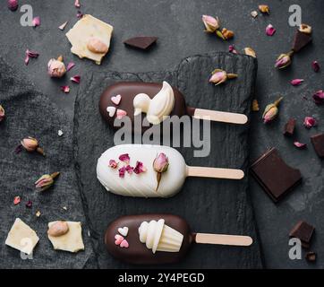 Blick von oben auf dekorierte Kuchen Pops Eis auf schwarzem Hintergrund Stockfoto