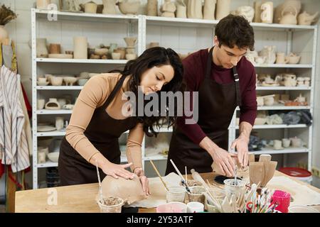 Ein Paar macht gerne Töpferei in einem hellen, künstlerischen Atelier und teilt dabei besondere Momente. Stockfoto