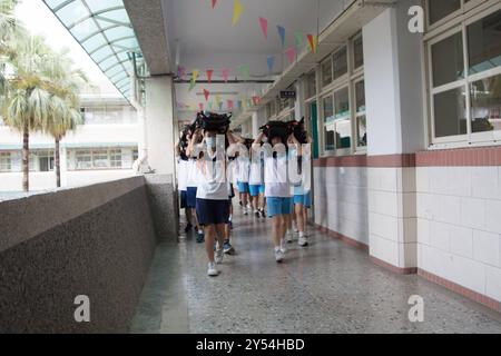 Schüler der Junior High School legten ihre Schultaschen auf den Kopf und gingen nach draußen, um an der jährlichen Erdbebenbohrung in Taipeh am 20. September 2024 teilzunehmen, um das Erdbeben 921 zu begehen. Taiwan wurde 1999 von einem Erdbeben der Stärke 7,2 erschüttert. Copyright: XJameson Wux Stockfoto