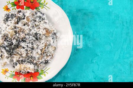 Gatot mit geriebenem Kokosnussbelag, Gatot ist ein typisches indonesisches Essen, das aus Maniok hergestellt wird, das einige Zeit getrocknet wird, um einen unverwechselbaren Bla zu produzieren Stockfoto