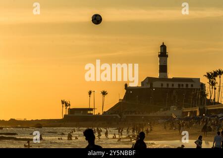 Salvador, Bahia, Brasilien - 6. Dezember 2019: Menschen werden bei Sonnenuntergang am Strand von Farol da Barra in Salvador, Bahia, beim Fußballspielen beobachtet. Stockfoto