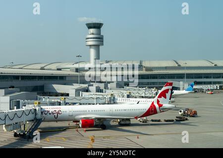 Ein Flugzeug der Air Canada rouge parkte am Pearson International Airport in Toronto mit Air Traffic Control Tower Stockfoto