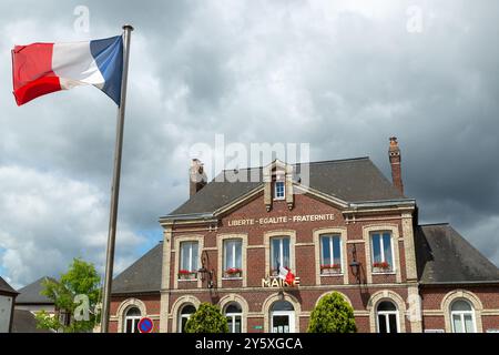 Eine französische Flagge, die vor dem Rathaus von Isneauville mit den Worten Liberte Egalite Fraternite, Isneauville, Normandie, Frankreich, fliegt Stockfoto