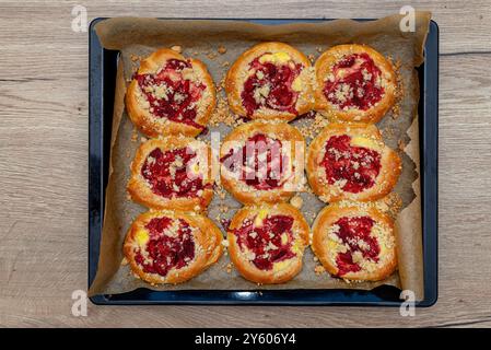 Handgemachter Hefekuchen mit Erdbeeren und Pudding, auf einem Backblech liegend. Stockfoto