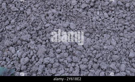 Feiner grauer, zerquetschter Stein als strukturierter Hintergrund Vollrahmen, Baustoffabschirmungen und Kies auf der Oberfläche verstreut, Abfallmaterial Stockfoto