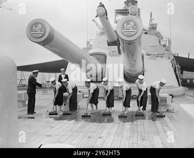 Avantgarde bereitet sich auf die Royal Australian Tour vor. Die Besatzung der HMS Vanguard freut sich mit großer Vorfreude auf die Royal Tour durch Australasien im nächsten Jahr und ist zu Recht stolz auf ihre Verbindung mit diesem großartigen Schiff, das jetzt in der Weymouth Bay (Dorset) liegt. Vor einer Shakedown-Kreuzfahrt nach Gibraltar und Malta am nächsten Freitag. Das Schiff erhält den letzten Schliff für die Tour, als es nach Devonport zurückkehrt. Das Bild zeigt: Mitglieder der Besatzung der Vanguard sind mit dem Schrubben und Waschen des Daches beschäftigt. 10. September 1948 Stockfoto