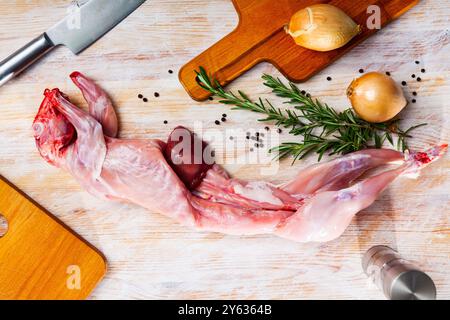 Rohes Kaninchen mit Zwiebeln und Gewürzen Stockfoto