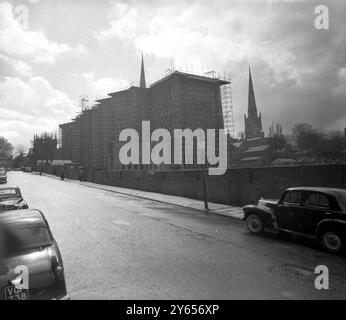 Blick von der Straße aus auf die neue Kathedrale von Coventry , die 1962 geweiht wird . Ganz links befindet sich ein Teil der kriegszerstörten ehemaligen Coventry Cathedral of St Michael , ein Gebäude aus dem 14. Jahrhundert , die neue Kathedrale wurde von Basil Spence entworfen . Es ist aus Hollington-Stein gebaut, außen rosa grau und innen weiß. Das Dach des Gebäudes , etwa 100 Fuß hoch , wird mit Kupfer bedeckt und von einem einzigen Slinderturm gekrönt sein . Das Schiff ist 270 Fuß lang und 80 Fuß breit. Die Krypta ist 86 Meter lang und hat eine Breite zwischen 30 und 60 Fuß . Es wird 500 Personen aufnehmen Stockfoto