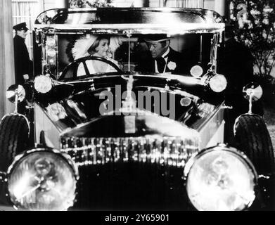 Wien : Ignorieren Sie die Menschen für einen Moment und konzentrieren Sie sich auf das Auto . Es ist ein älterer Rolls Royce. Wie bei den meisten Qualitätstechniken könnte es sicherlich einige Geschichten erzählen. Die Filmproduzentin Anatole de Grunwald hat beschlossen, genau das zu lassen . Sein neuer Film " The Yellow Rolls - Royce " erzählt das Vermögen einiger der Besitzer des Autos . Zum Beispiel ...(TOP) Rex Harrison und Jeanne Moreau , die in den besseren Tagen des Autos mit viel Rennsport fahren . 5. Juni 1964 Stockfoto