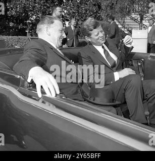 Der irische Premierminister Sean Lemass, der derzeit die Vereinigten Staaten besucht, unterhält sich mit US-Präsident John F. Kennedy, während er auf dem Rücksitz eines Autos vor einer Parade wartet, Washington DC, USA 17. Oktober 1963 Stockfoto