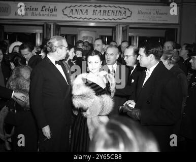 Vivien Leigh kommt am Leicester Square Theatre in London zur Uraufführung von Anna Karenina, in der sie Hauptrolle spielt. Auf der rechten Seite sind ihr Ehemann Sir Laurence Olivier und der linke Produzent Alexander Korda. Januar 1948 Stockfoto