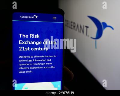 In dieser Abbildung hält eine Person ein Mobiltelefon mit der Webseite des US-amerikanischen Risk Exchange-Unternehmens Accelerant vor dem Geschäftslogo. Stockfoto