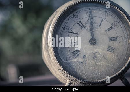 Nahaufnahme und Detail einer alten verwitterten und schmutzigen Vintage Retro-Uhr, die Mitternacht oder Mittag anzeigt. 12 Std Stockfoto