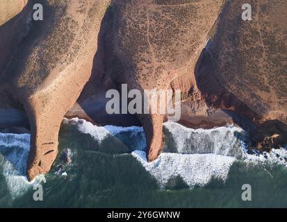 Antenne Draufsicht auf Legzira Strand mit gewölbten Felsen auf der atlantischen Küste bei Sonnenuntergang in Marokko Stockfoto