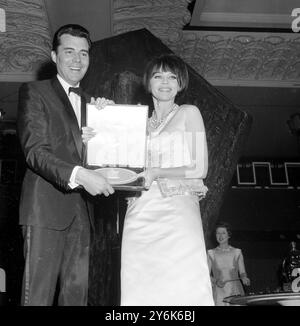 London : britischer Filmstar Dirk Bogarde erhält seinen British Film Academy Award für den besten britischen Schauspieler für seine Darling - Darling - Darling von der Schauspielerin Leslie Caron in der Grand Hall im Grosvenor House . 23. März 1966 Stockfoto