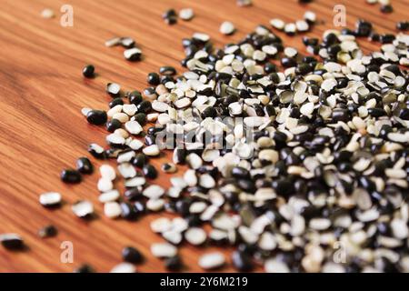 Split Black Linse auch bekannt als Black Gram, Black urad Dal, Vigna Mungo, urad Bean auf braunem hölzernem Hintergrund Stockfoto