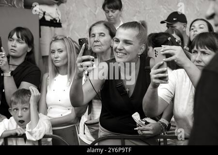 ODESSA, UKRAINE - 21. September 2024: Kinderjugendsport. Emotionale Eltern machen Fotos von den Gewinnern ihrer Kinder auf ihrem Phon Stockfoto