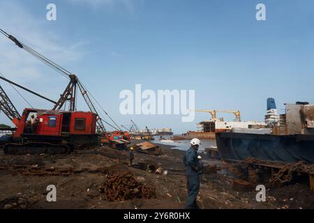 Die intensive industrielle Tätigkeit der Werft Alang, wo stillgelegte Schiffe abgebaut werden. Dieses Bild zeigt den sorgfältigen Abbruchprozess des Schiffes Stockfoto