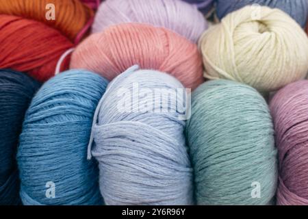 Colourful balls of yarn in storage. Warm wool yarn background. Knitting hobby. Multicoloured yarn. Handiwork store. Knit background. Handcraft concept Stockfoto