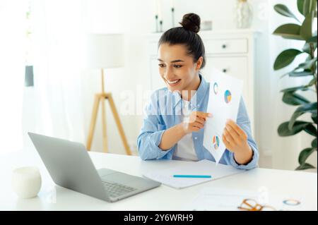 Erfolgreiche weiße junge Frau, ceo des Unternehmens, sitzt an einem Schreibtisch mit Laptop, hält Online-Geschäftstreffen mit Kollegen, Brainstorming mit Partnern, hält Präsentationen per Videokonferenz mit Kunden Stockfoto