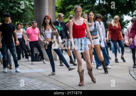 New Yorker und Besucher tanzen im Bella Abzug Park in New York am Mittwoch, den 26. September 2024 während des Line Dancing Workshops im Park. Am Abend zogen die Tänzer ihre Stiefel an und tanzten einen Sturm in der Werkstatt der Big Apple Ranch. Der Tanz ist nur eine der vielen Aktivitäten, die die Hudson Yards Hells Kitchen Alliance im Bella Abzug Park durchführt. (© Richard B. Levine) Stockfoto
