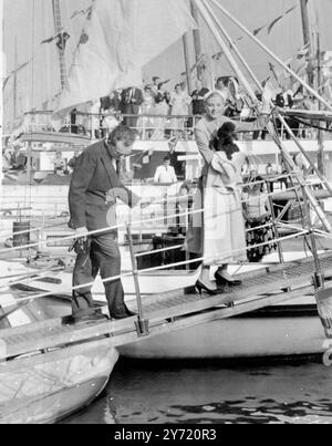 Auf ihren Flitterwochen Monaco: Prinz Rainier III. Und Prinzessin Grace Patricia von Monaco, mit ihrem schwarzen Poodle, an Bord der Yacht des Prinzen, der 'Deo Juvante', in Monaco für ihre Flitterwochen entlang der italienischen Küste. Sie fuhren nach dem Hochzeitsempfang vom Palast zum Hafen. 19. April 1956 Stockfoto