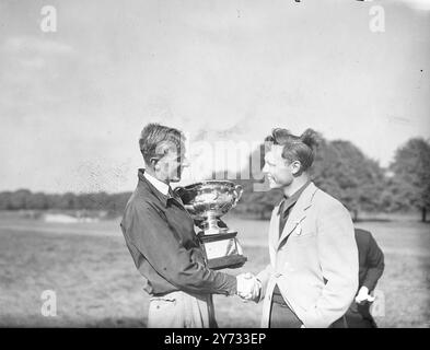 Ian Patey und Kenneth Thom bestritten das Finale der English Amateur Golf Championship auf dem Golfplatz des Royal Mid-Surrey Clubs in Richmond. Das Bild zeigt den Sieger Ian Patey, der seinen Pokal hält, während er Thom nach dem Spiel die Hand schüttelt. 4. Mai 1946 Stockfoto