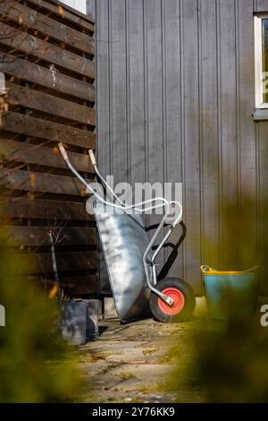 Göteborg, Schweden - 02. März 2023: schubkarre gegen einen Zaun in einem Garten verstaut Stockfoto