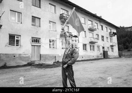 Kirgisistan, Dorf Djety-Oguz, Kind, das die kirgisische Flagge schwenkt Stockfoto